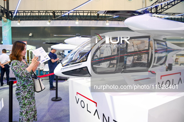 Visitors are visiting an electric vertical take-off and landing vehicle at The 10th China (Shanghai) International Technology Fair in Shangh...