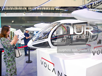 Visitors are visiting an electric vertical take-off and landing vehicle at The 10th China (Shanghai) International Technology Fair in Shangh...