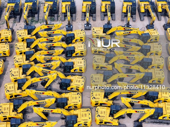 A batch of Chinese-made excavators is waiting to be loaded for export at Yantai Port in Yantai, China, on June 13, 2024. On June 7, 2024, da...