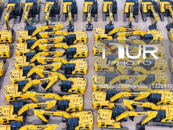 A batch of Chinese-made excavators is waiting to be loaded for export at Yantai Port in Yantai, China, on June 13, 2024. On June 7, 2024, da...