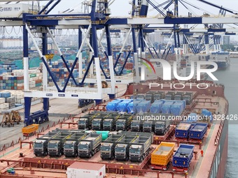 A batch of Chinese-made trucks is being loaded for export at Yantai Port in Shandong province, in Yantai, China, on June 13, 2024. Data rele...