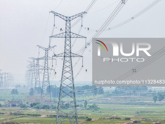 Power supply workers are carrying out acceptance work on a new 500-kilovolt transmission line in Nanjing, Jiangsu province, China, on June 1...