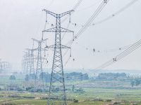 Power supply workers are carrying out acceptance work on a new 500-kilovolt transmission line in Nanjing, Jiangsu province, China, on June 1...