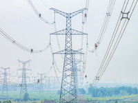 Power supply workers are carrying out acceptance work on a new 500-kilovolt transmission line in Nanjing, Jiangsu province, China, on June 1...