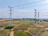 Power supply workers are carrying out acceptance work on a new 500-kilovolt transmission line in Nanjing, Jiangsu province, China, on June 1...