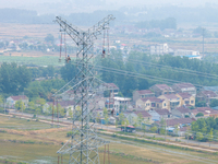 Power supply workers are carrying out acceptance work on a new 500-kilovolt transmission line in Nanjing, Jiangsu province, China, on June 1...