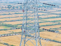 Power supply workers are carrying out acceptance work on a new 500-kilovolt transmission line in Nanjing, Jiangsu province, China, on June 1...