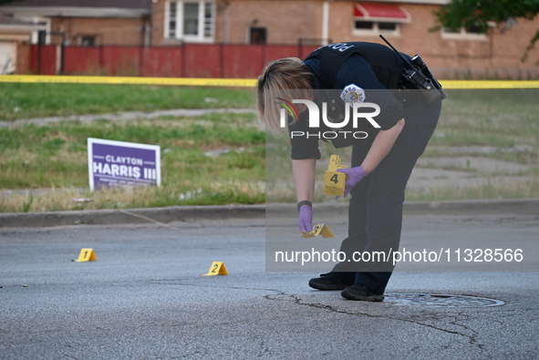 Over 29 evidence markers are being placed at the crime scene, highlighting where shell casings are being recovered by the Chicago police. A...