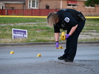 Over 29 evidence markers are being placed at the crime scene, highlighting where shell casings are being recovered by the Chicago police. A...