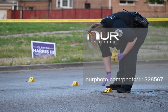 Over 29 evidence markers are being placed at the crime scene, highlighting where shell casings are being recovered by the Chicago police. A...