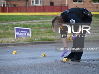 Over 29 evidence markers are being placed at the crime scene, highlighting where shell casings are being recovered by the Chicago police. A...