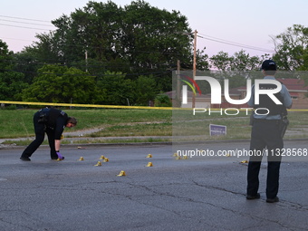 Over 29 evidence markers are being placed at the crime scene, highlighting where shell casings are being recovered by the Chicago police. A...