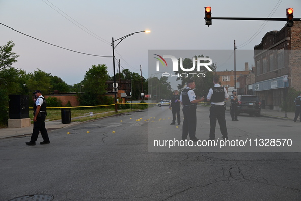 Over 29 evidence markers are being placed at the crime scene, highlighting where shell casings are being recovered by the Chicago police. A...