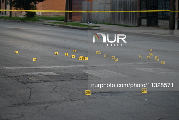 Over 29 evidence markers are being placed at the crime scene, highlighting where shell casings are being recovered by the Chicago police. A...