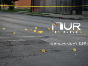 Over 29 evidence markers are being placed at the crime scene, highlighting where shell casings are being recovered by the Chicago police. A...