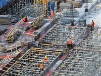 Workers are working outdoors at a commercial housing construction site in Nanjing, China, on June 14, 2024, when the temperature is exceedin...