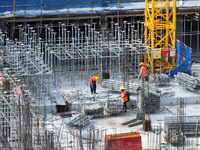 Workers are working outdoors at a commercial housing construction site in Nanjing, China, on June 14, 2024, when the temperature is exceedin...