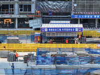 Workers are working outdoors at a commercial housing construction site in Nanjing, China, on June 14, 2024, when the temperature is exceedin...