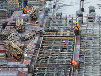 Workers are working outdoors at a commercial housing construction site in Nanjing, China, on June 14, 2024, when the temperature is exceedin...