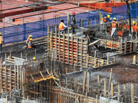 Workers are working outdoors at a commercial housing construction site in Nanjing, China, on June 14, 2024, when the temperature is exceedin...