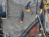 Workers are working outdoors at a commercial housing construction site in Nanjing, China, on June 14, 2024, when the temperature is exceedin...