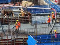 Workers are working outdoors at a commercial housing construction site in Nanjing, China, on June 14, 2024, when the temperature is exceedin...