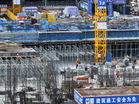 Workers are working outdoors at a commercial housing construction site in Nanjing, China, on June 14, 2024, when the temperature is exceedin...