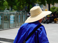 Citizens are wearing sun protection clothes to travel in Yichang, China, on June 14, 2024. (