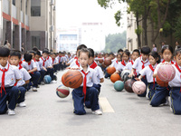 Primary school students are demonstrating basketball exercises at a school in Suqian, Jiangsu province, China, on June 14, 2024. (