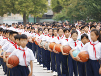 Primary school students are demonstrating basketball exercises at a school in Suqian, Jiangsu province, China, on June 14, 2024. (