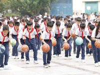 Primary school students are demonstrating basketball exercises at a school in Suqian, Jiangsu province, China, on June 14, 2024. (