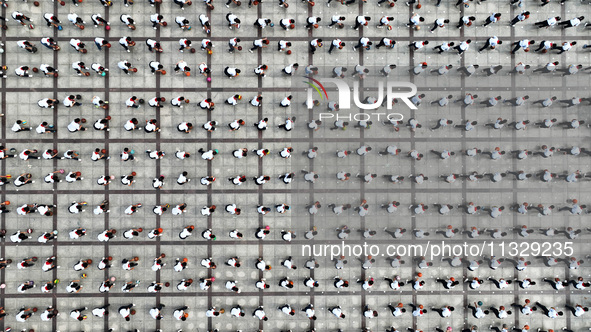 Primary school students are demonstrating basketball exercises at a school in Suqian, Jiangsu province, China, on June 14, 2024. 