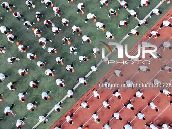 Primary school students are demonstrating basketball exercises at a school in Suqian, Jiangsu province, China, on June 14, 2024. (