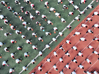 Primary school students are demonstrating basketball exercises at a school in Suqian, Jiangsu province, China, on June 14, 2024. (