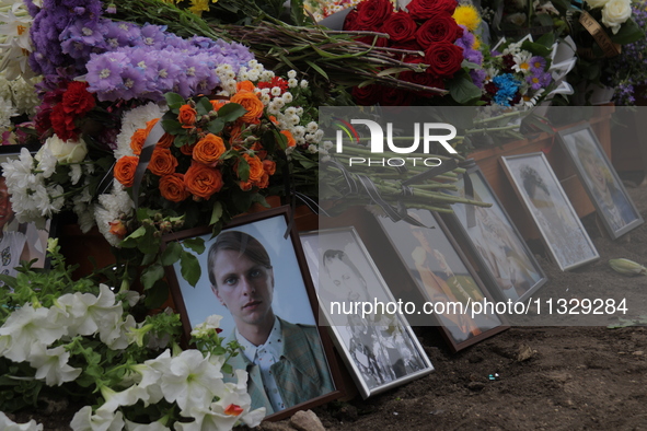 Photographs and flowers are being pictured at the grave of Ukrainian serviceman, artist, musician, stylist, and queer community member Artur...