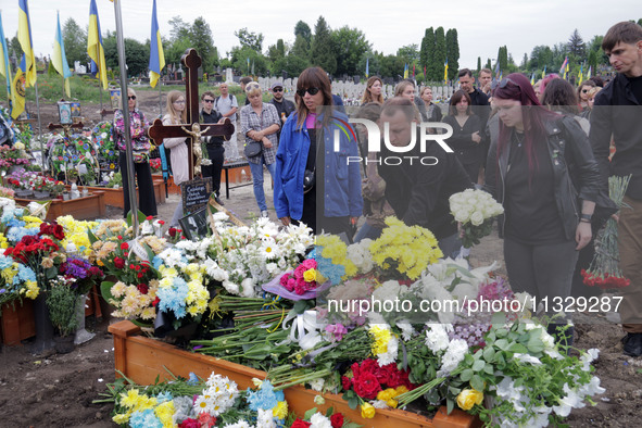 People are laying flowers at the grave of Ukrainian serviceman, artist, musician, stylist, and queer community member Artur Snitkus, 36, who...