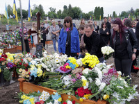 People are laying flowers at the grave of Ukrainian serviceman, artist, musician, stylist, and queer community member Artur Snitkus, 36, who...