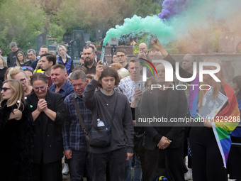 Mourners are holding smoke bombs during the funeral of Ukrainian serviceman, artist, musician, stylist, and queer community member Artur Sni...