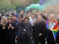 Mourners are holding smoke bombs during the funeral of Ukrainian serviceman, artist, musician, stylist, and queer community member Artur Sni...