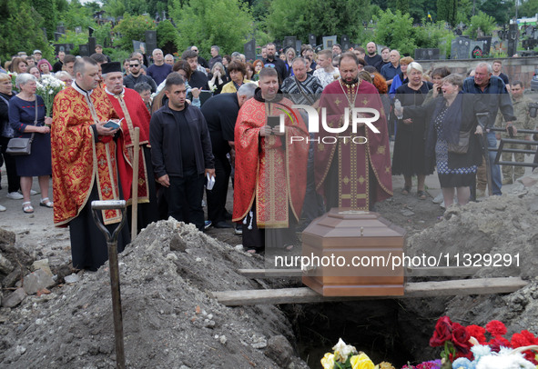 Priests are conducting the funeral of Ukrainian serviceman, artist, musician, stylist, and queer community member Artur Snitkus, 36, who per...