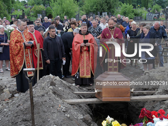 Priests are conducting the funeral of Ukrainian serviceman, artist, musician, stylist, and queer community member Artur Snitkus, 36, who per...