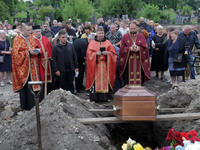 Priests are conducting the funeral of Ukrainian serviceman, artist, musician, stylist, and queer community member Artur Snitkus, 36, who per...