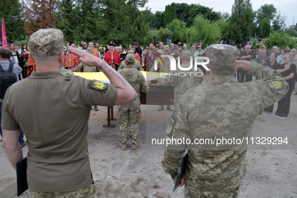 Soldiers are saluting at the coffin of Ukrainian serviceman, artist, musician, stylist, and queer community member Artur Snitkus, 36, who pe...