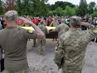 Soldiers are saluting at the coffin of Ukrainian serviceman, artist, musician, stylist, and queer community member Artur Snitkus, 36, who pe...