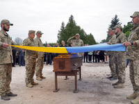 Soldiers are covering the coffin of Ukrainian serviceman, artist, musician, stylist, and queer community member Artur Snitkus, 36, who peris...