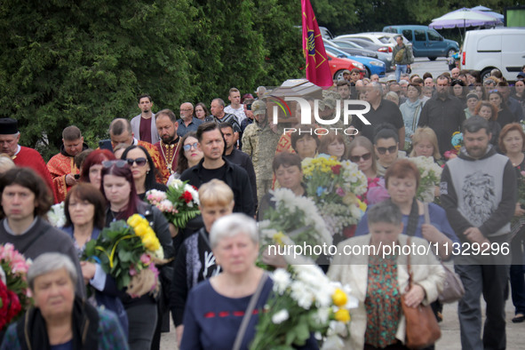 Soldiers are carrying the coffin of Ukrainian serviceman, artist, musician, stylist, and queer community member Artur Snitkus, 36, who peris...