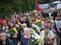 Soldiers are carrying the coffin of Ukrainian serviceman, artist, musician, stylist, and queer community member Artur Snitkus, 36, who peris...