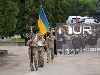 The funeral procession of Ukrainian serviceman, artist, musician, stylist, and queer community member Artur Snitkus, 36, who perished in act...