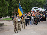 The funeral procession of Ukrainian serviceman, artist, musician, stylist, and queer community member Artur Snitkus, 36, who perished in act...