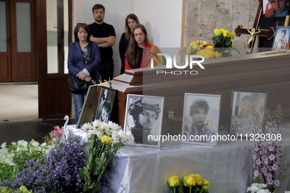 Photographs are being pictured at the coffin during the memorial service of Ukrainian serviceman, artist, musician, stylist, and queer commu...